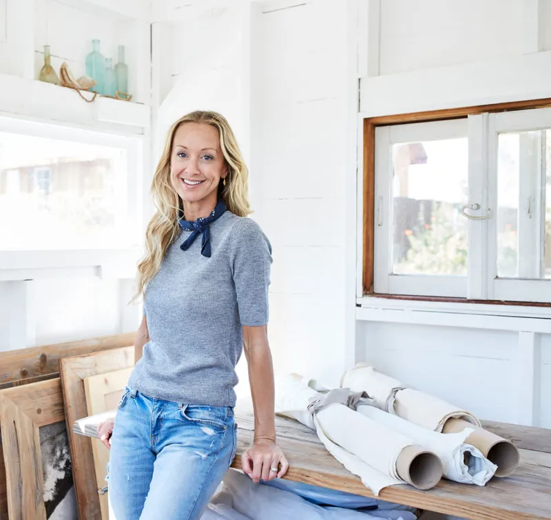 A smiling woman in a bright workspace